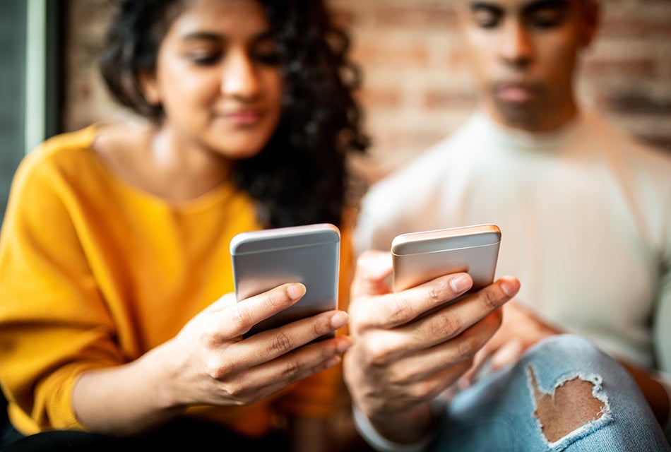 two people looking at their phones