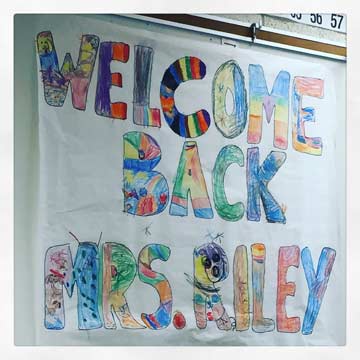 Julianne receives a welcome back poster from her class