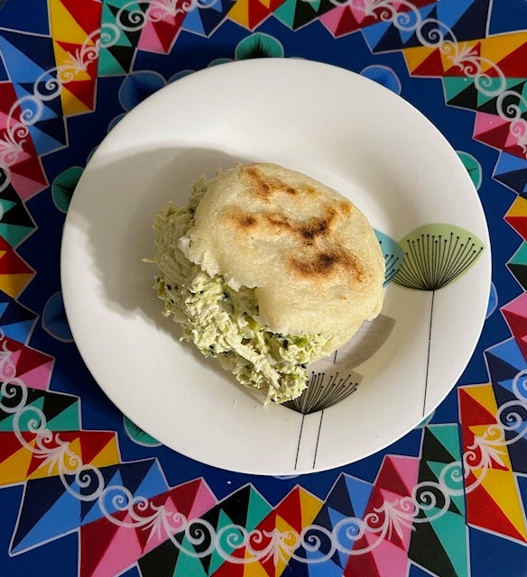 Arepa filled with a creamy, savory chicken-avocado salad