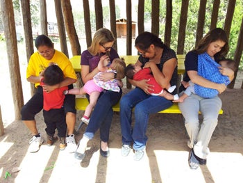 Four women breastfeeding their children.
