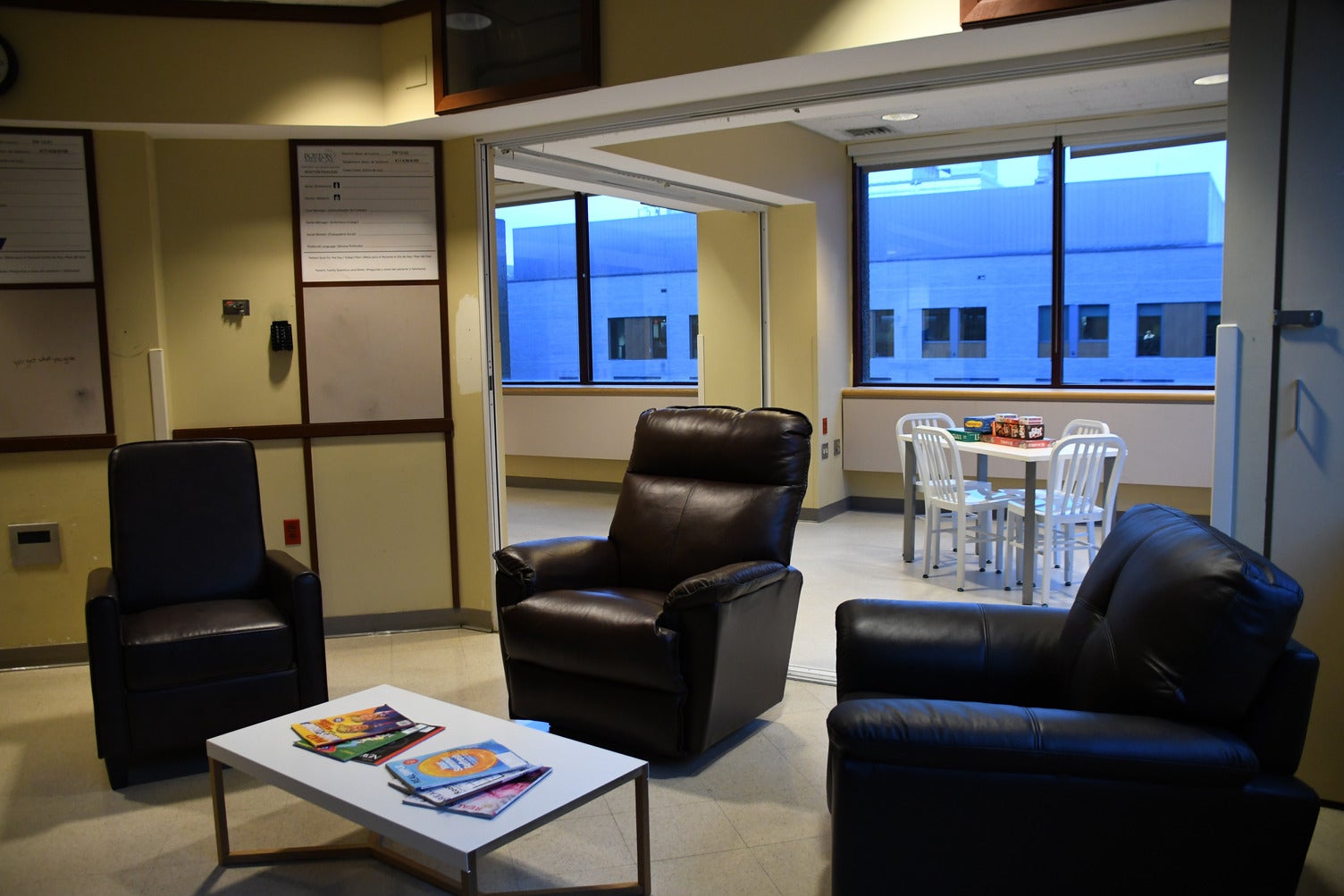 A communal space at the East Newton Pavillion respite center with lounge chairs and board games