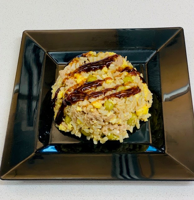 Chicken and eggs fried rice served with Hoisin Sauce on top.
