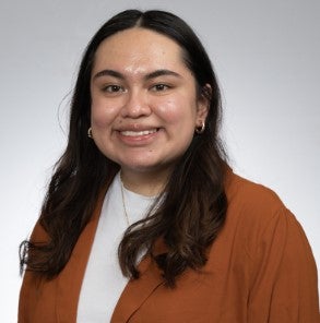woman in orange blazer and white shirt