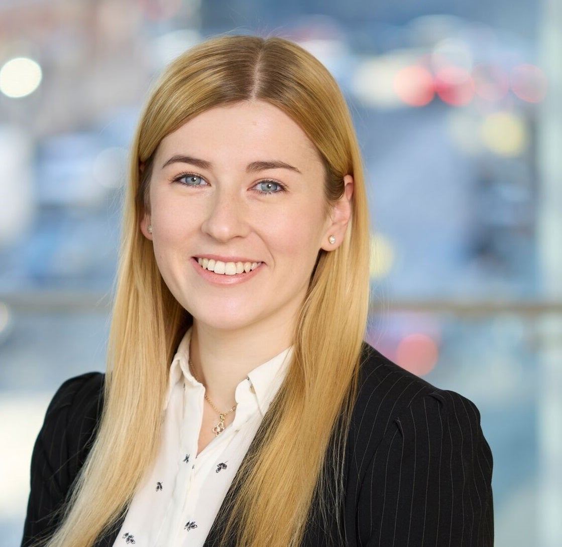blonde woman wearing a white shirt and black jacket