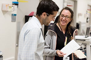 Pediatric Rheumatologists talking and smiling in hospital
