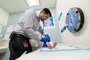 Pediatric Rheumatologist caring for baby