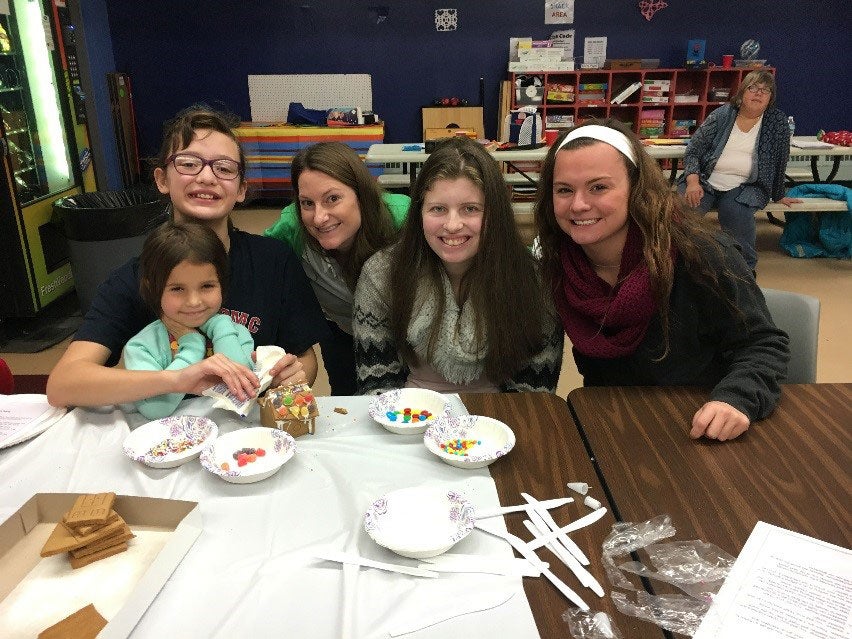 Making gingerbread houses at a holiday party.