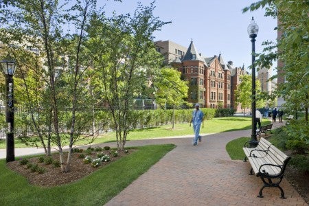 Doctor walking across BU lawn