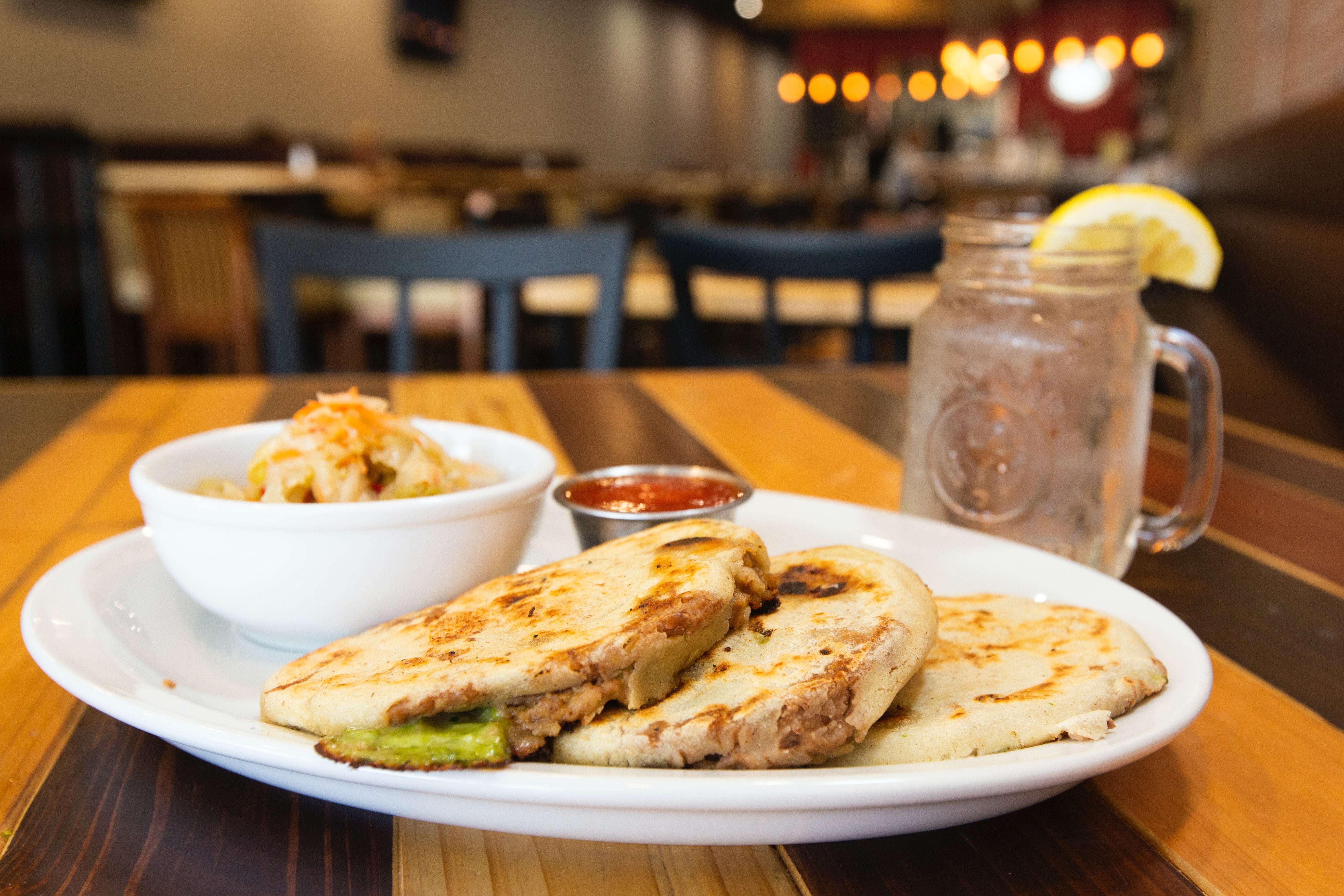 Pupusa with refried bean and curtido