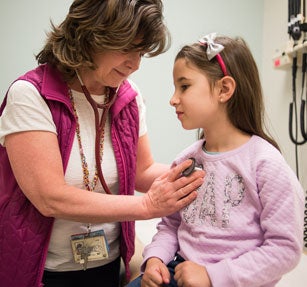 female physician working with female toddler