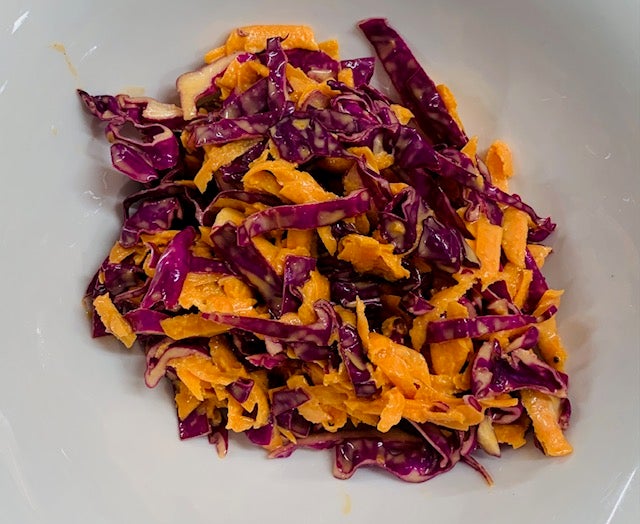 Red Cabbage and Carrot slaw on a white plate