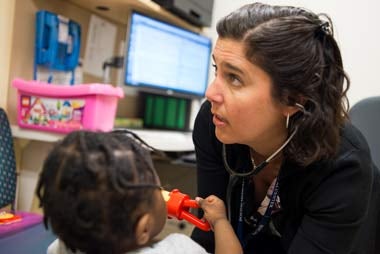 female physician working with female toddler