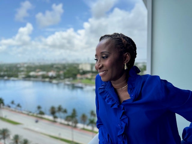 Photo of Titilayo (Titi) Ilori looking out over a balcony.