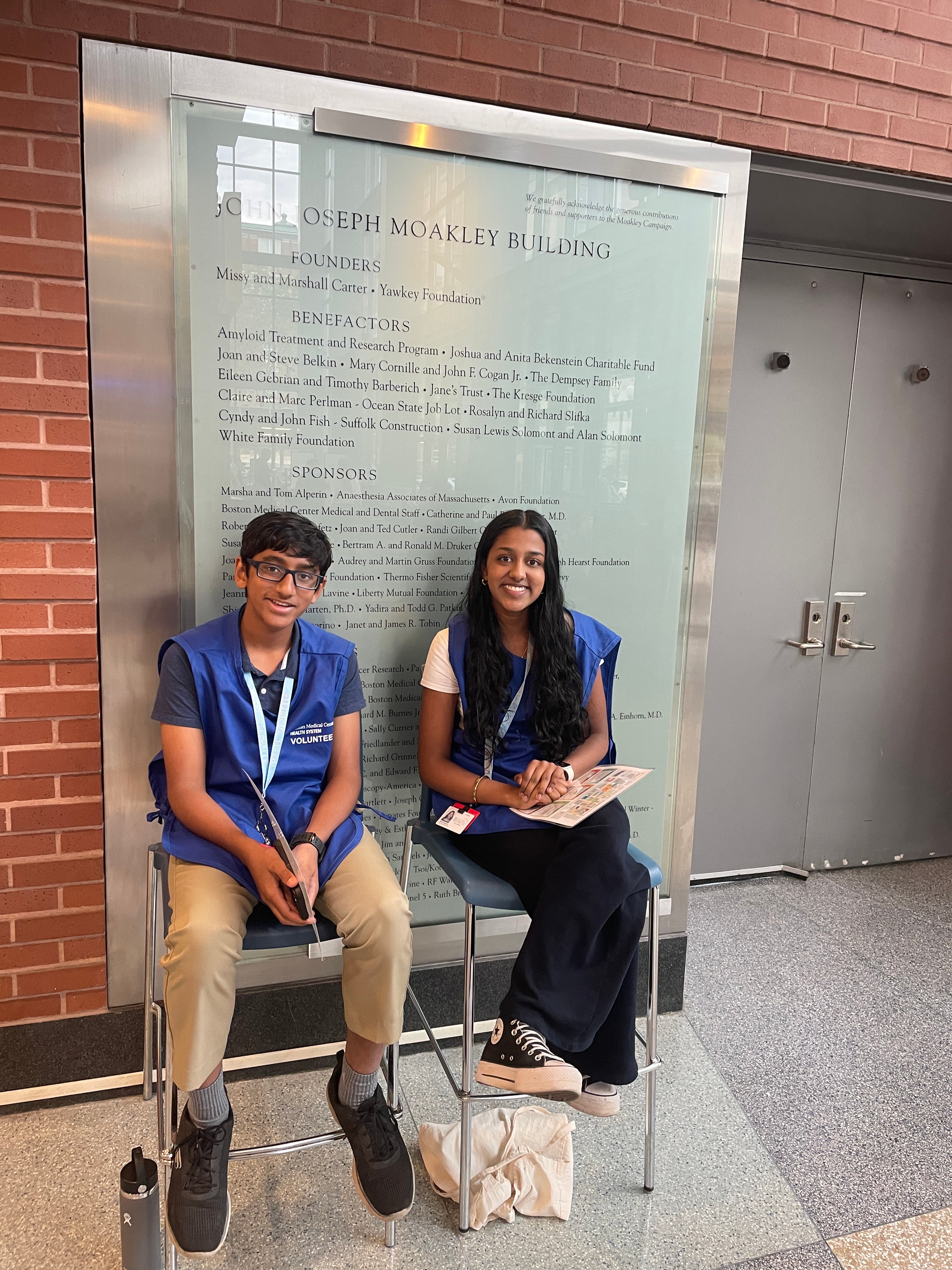 Two volunteers sitting on chairs