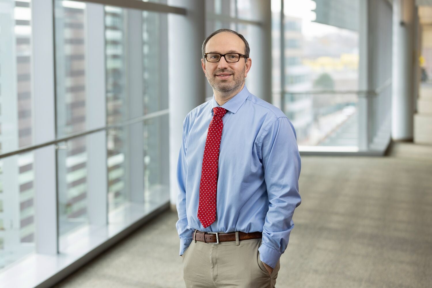 Mark H. Katz, MD, urologist at Boston Medical Center, standing in a sunlit hallway that overlooks downtown Boston