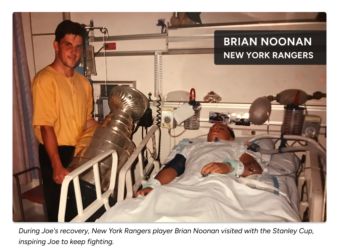 Historic photo of Joe recovering in a hospital bed as New York Rangers player Brian Noonan visits with the Stanley Cup, a surprise visit that encouraged Joe during his recovery.