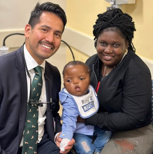 In Boston, Marilande Pierre (right) and her son Michel (center) found support at BMC with craniofacial surgeon Dr. Jorge Lujan (left).