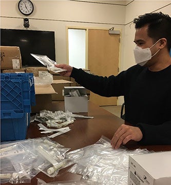 BMC volunteer sorting mail