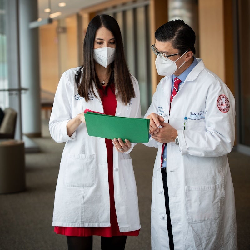BMC urologist Dr. Toby Chai and another member of his team conferring over a file
