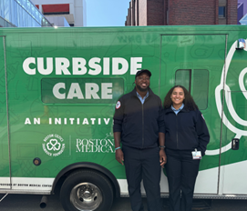 two people standing in front of the curbside care van