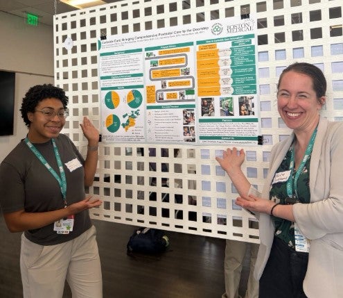 two women with a research poster