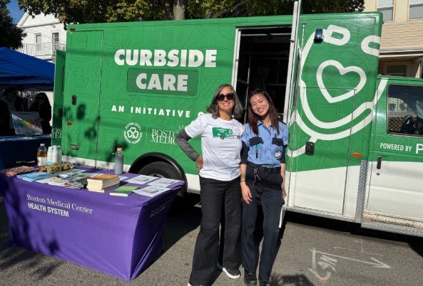 two women in front of curbside care van