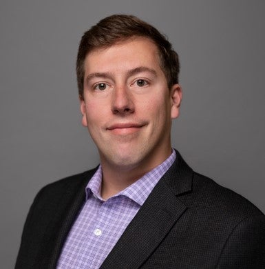man in purple shirt and blue suit