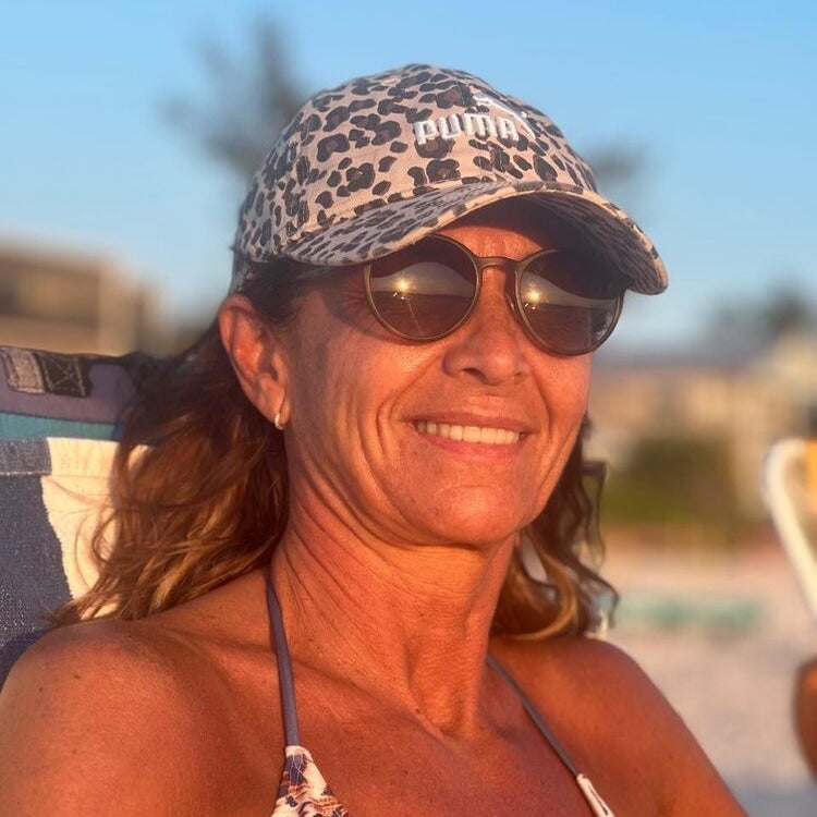 BMC rheumatology patient Sandra Melchor wearing sunglasses and looking happy and well during a trip to the beach