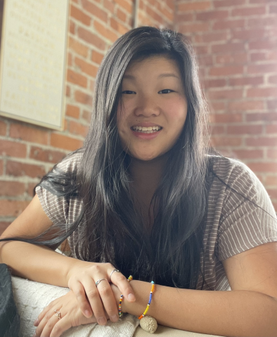 woman in front of brick wall
